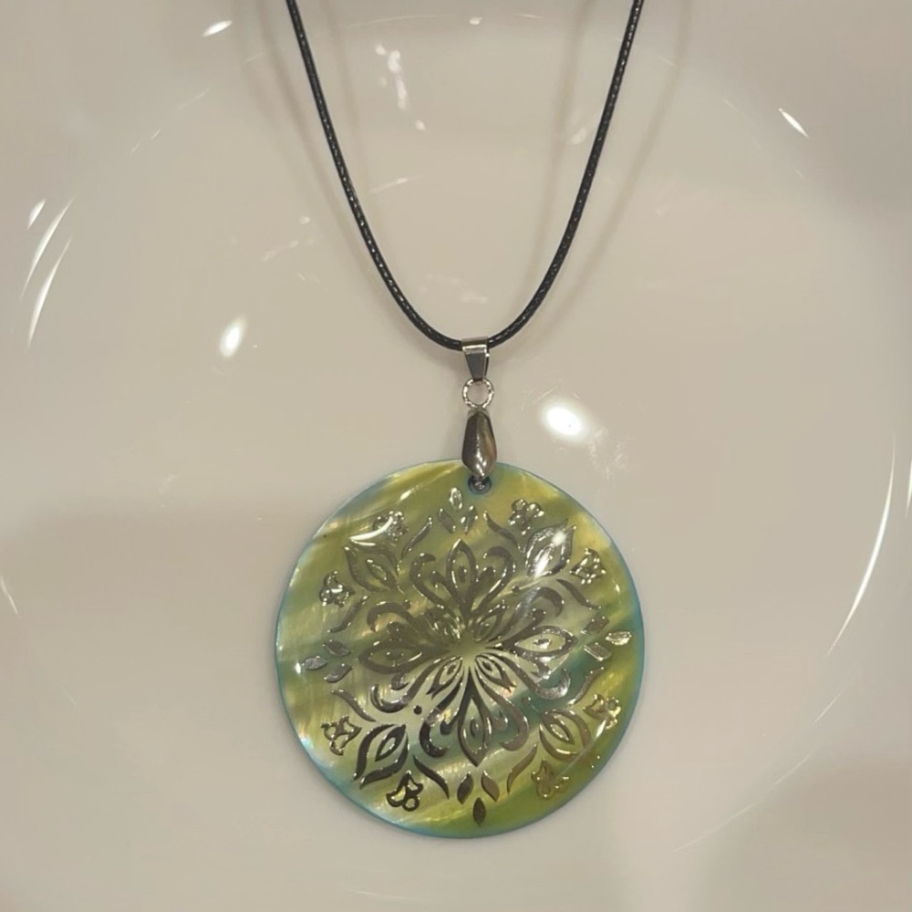 green pendant on black rope necklace 💚
